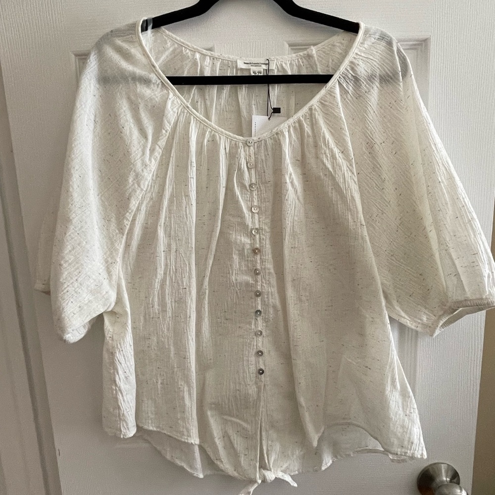 Short sleeved, tie waisted, button down white shirt with rainbow accents